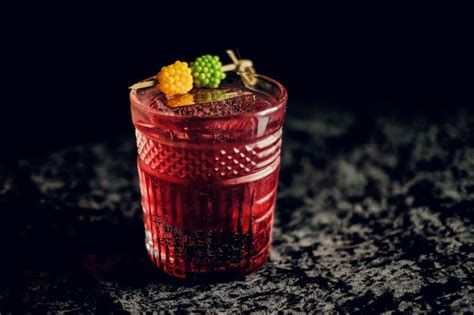 Premium Photo Red Berry Cocktail In A Beautiful Glass On A Dark Surface