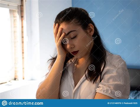 Woman With A Disappointed Face In Front Of The Mirror Stock Photo
