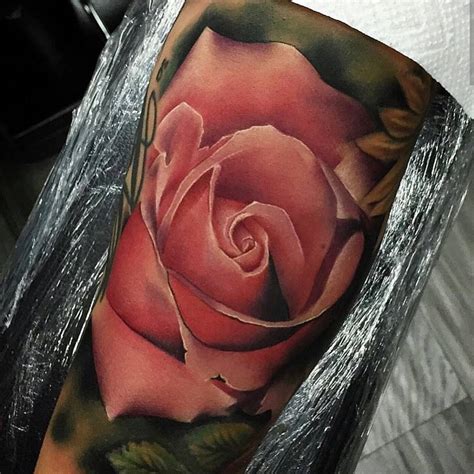 With the stunning red flower blossoming at the very top, it is surrounded by bright green leaves. Rose Tattoo Arm | Best Tattoo Ideas Gallery