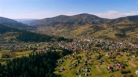 Aerial View On The Small Town With Houses Pinewood Surrounded Mountain