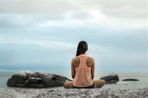 Woman Meditating On A Rock At Sunset On Bakovern Beach Cape Town Stock Image Image Of