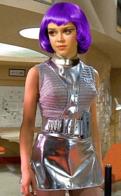 a woman with purple hair in a silver dress