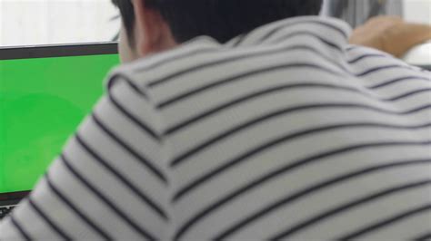Over The Shoulder Shot Of Asian Boy Looking At Green Screen Home