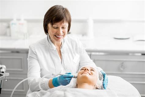 Senior Woman Cosmetologist During The Procedure Stock Photo Image Of