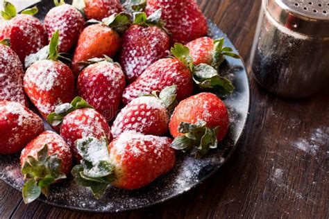 Fresh Organic Ripe Strawberries With Powdered Sugar On Black Plate