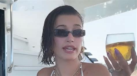 hailey bieber flashes her bare stomach in tiny blue bikini on yacht trip as fans think she s