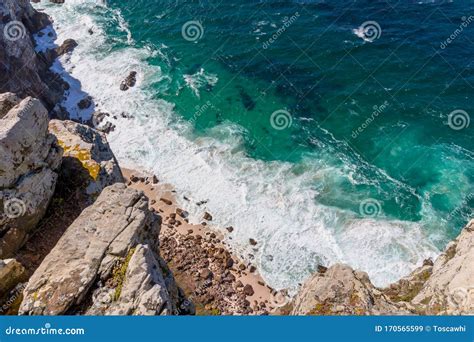 View Over The Cliffs At The Deep Ocean And Waves Swirling At Small
