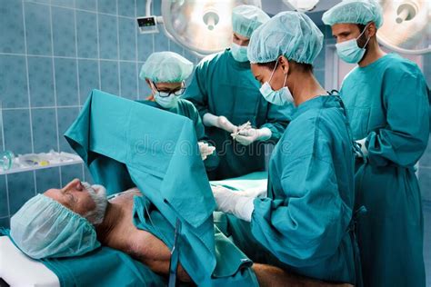 Group Of Surgeon Doctor Team At Work In Operating Room Stock Image