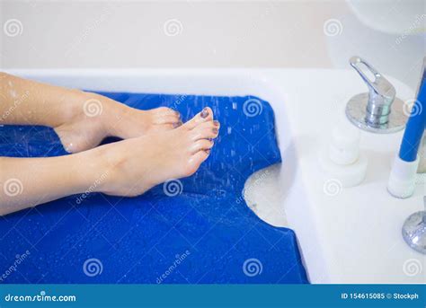 Beautiful Legs Of A Young Girl Under A Stream Of Water Vichy Shower