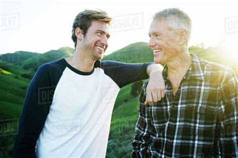 Caucasian Father And Son Smiling On Rural Hilltop Stock Photo Dissolve