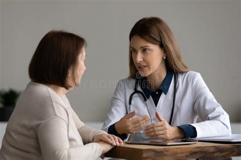 Smiling Female Gp Consult Mature Woman Client Stock Photo Image Of