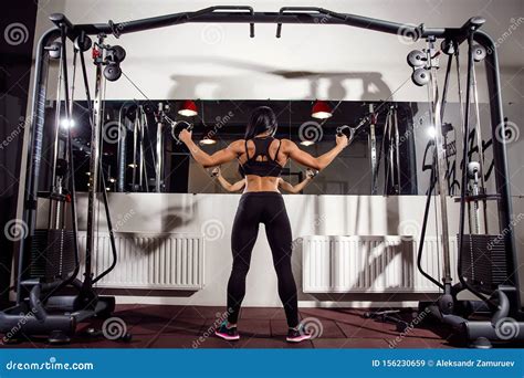 Woman Flexing Muscles On Cable Machine In Gym Stock Image Image Of