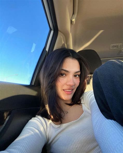 A Woman Sitting In The Back Seat Of A Car