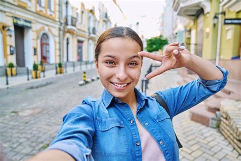 Selfie Portrait Of Beautiful Cheerful Teenage Girl Outdoor On City