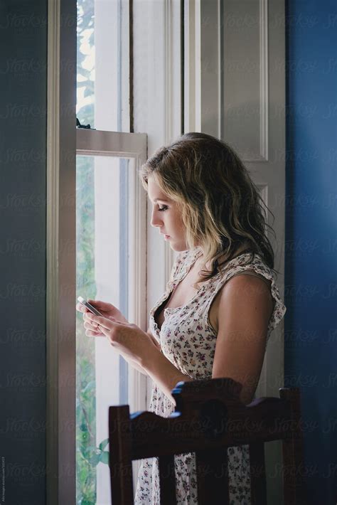 beautiful girl using her phone by stocksy contributor aila images