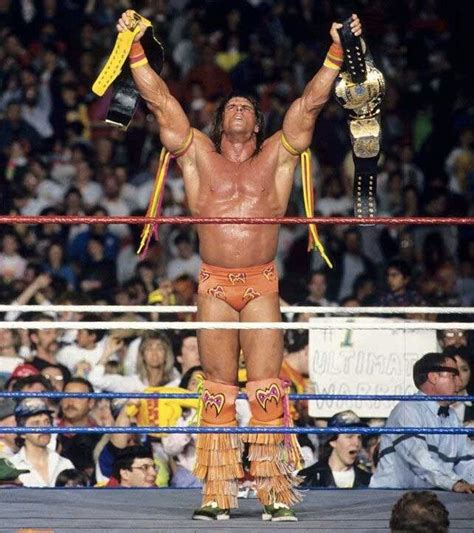 The Wrestler Is Holding His Arms Up In Victory