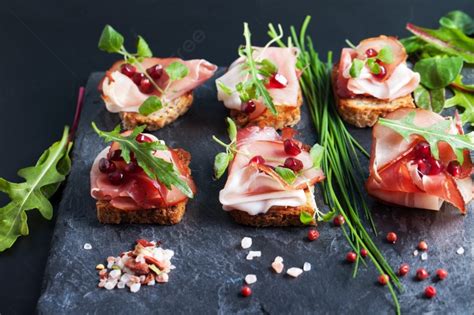Sliced Prosciutto With Herbs And Pomegranate Seeds Photo Background And