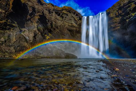 A Beautiful Double Rainbow Forms Over The Skógafoss Waterfalls In