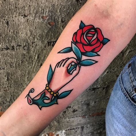 Hand Holding Rose Tattoo