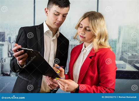 Female Mentor Coach Worker Talking To Male Coworker About The Development Of The Company Stock