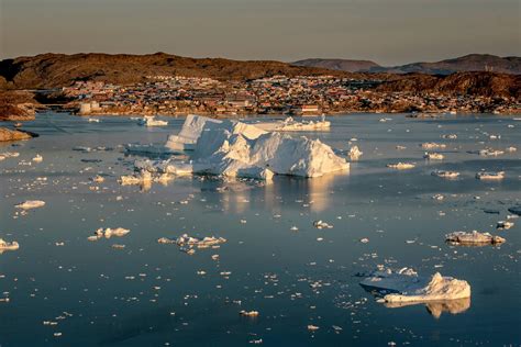 Ilulissat In Greenland With Icebergs From The Ice Fjord Outside In The