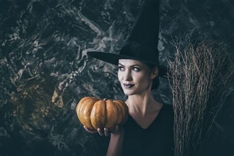 Premium Photo Halloween Witch Holding A Pumpkin And A Broom