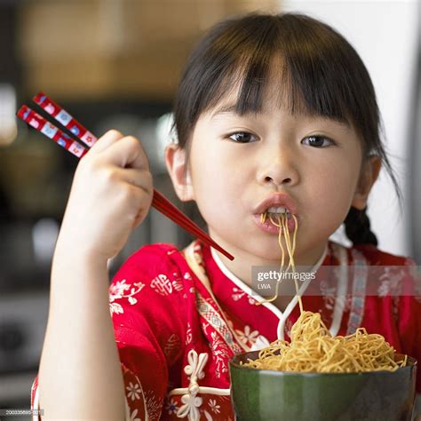 Girl Eating Noodles With Chopsticks Portrait Closeup Bildbanksbilder