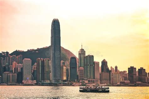 Star Ferry At Victoria Harbor And Hk Skyline At Sunset Stock Photo