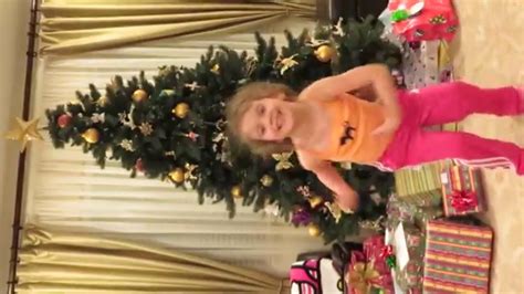 Ifia Adorable 4 Year Old Jumping In Front Of Christmas Tree Sideways