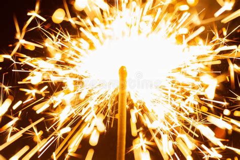 Close Up Of Golden Blurry Sparks Burn In The Dark Stock Photo Image