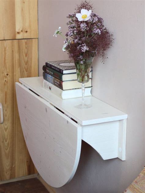 Wheeled cabinets with drop leaf sides this wall mounted work table with drop leaf creates a nice, romantic spot to share a meal. Wall mounted drop leaf table Fold down desk Wall mounted desk Kitchen table Side table Space ...