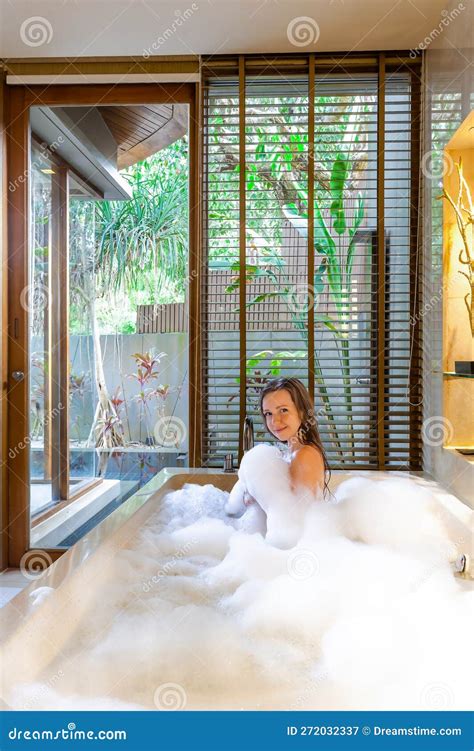 Beautiful Naked Woman Enjoying A Relaxing Soak In A Foam Filled Bathtub