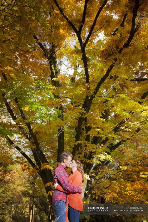 Happy Young Couple Kissing In Autumnal Park — Intimacy Male Stock