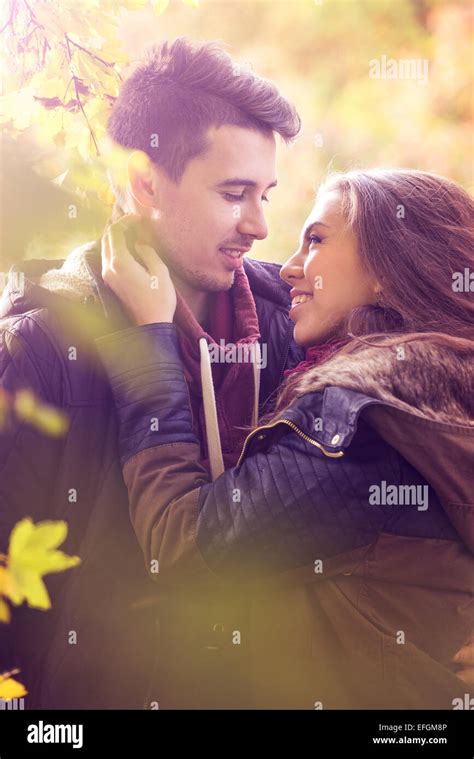 Couple Kissing In The Colorful Autumn Forest Stock Photo Alamy
