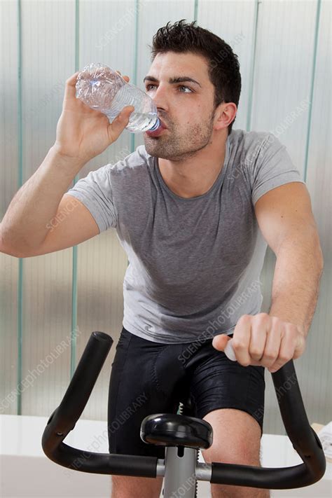 Man Drinking Water On Exercise Machine Stock Image F0053528