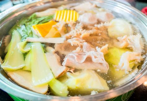 Shabu Shabu Or Sukiyaki Or Hot Pot Hand Holding Pork Using Chopsticks