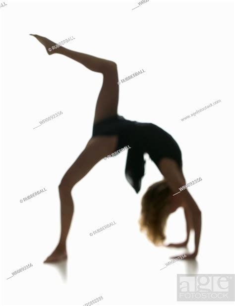 Side Profile Of A Young Woman Bending Over Backwards Stock Photo