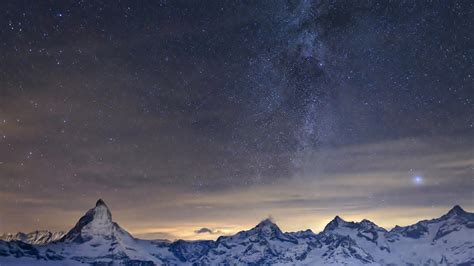 Snow Covered Mountain Under Sunset Sky With Blue Stars Hd