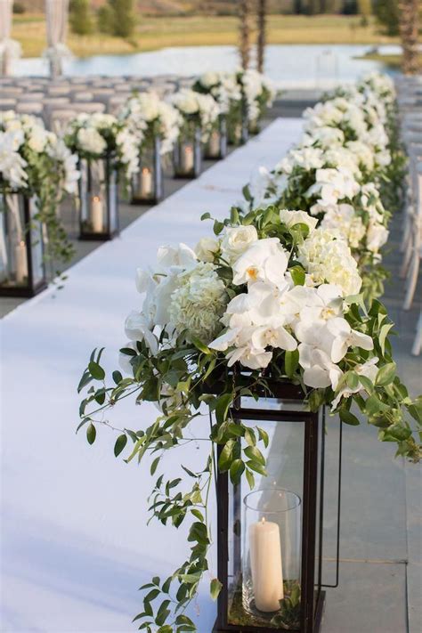 Lantern Aisle Markers With White Flowers Double As Centerpieces