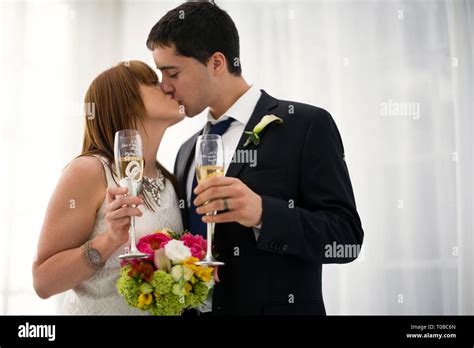 Bride And Groom Kissing At Wedding Reception Stock Photo Alamy