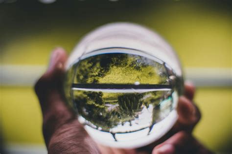 Person Holding Glass Ball · Free Stock Photo