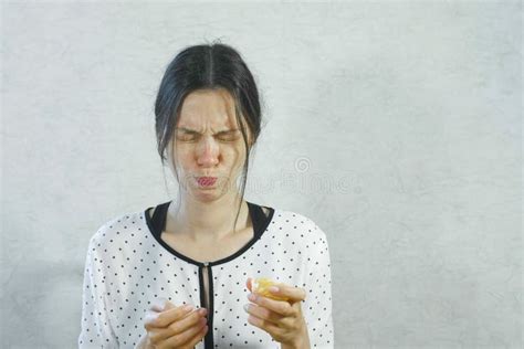Emotions From The Sour On The Girl`s Face Brunette Woman Eating Sour