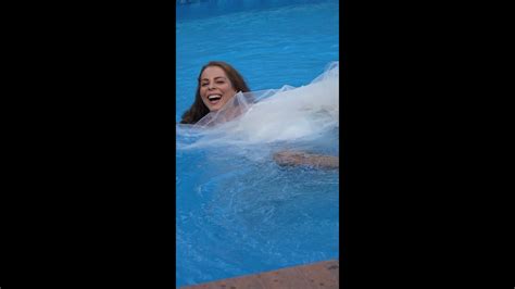 Bride Jumps In The Swimming Pool Away From Her Groom In The Wedding