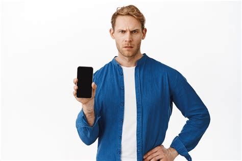 Free Photo Handsome Young Man Showing Mobile Phone Display