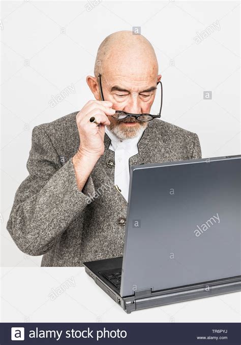 Old Man With Bald Head And Grey Beard At A Laptop Germany Bavaria