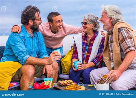 Group Of Four People Of All Ages Together At Home In The Balcony