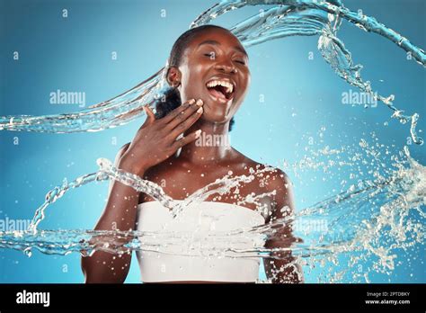 Water Splash And Woman Washing For Hygiene And Grooming On A Blue