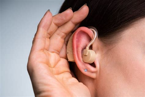 Woman Inserting Hearing Aid In Her Ear Stock Image Image Of Health Inserting 249173473