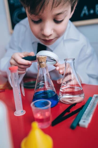 Premium Photo Close Up Of Boy Doing Scientific Experiment On Table In
