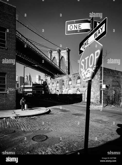 Traffic Signs And Old Storage Houses Under The Brooklyn Bridge Water
